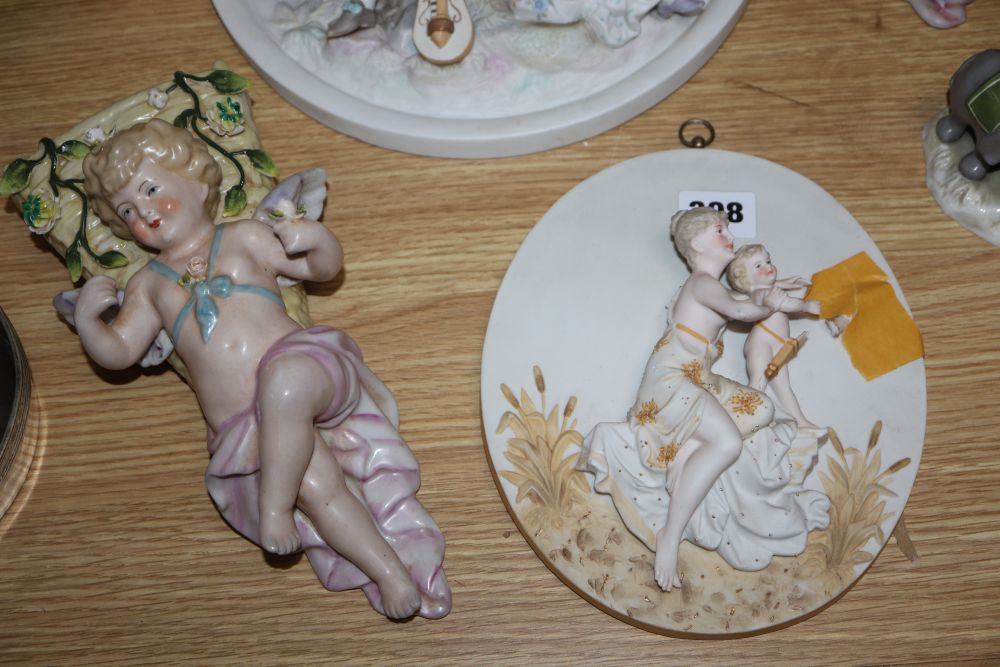 A group of Continental porcelain wall plaques and pockets and a figure group